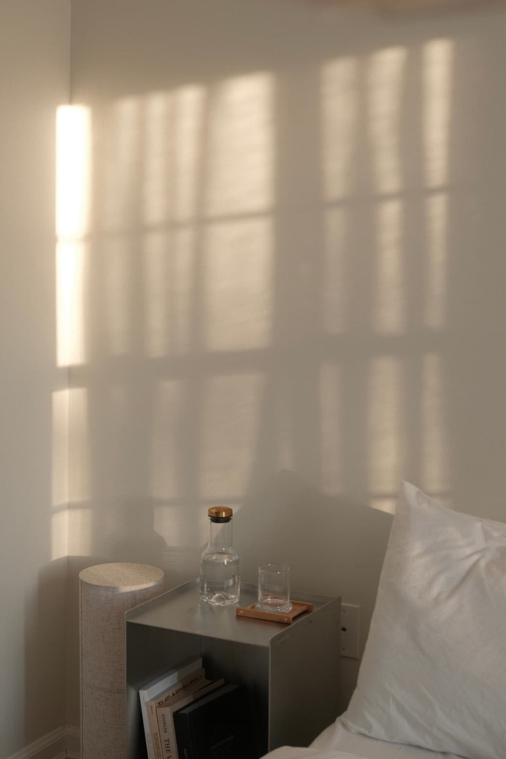 Late sun through a window, falling in squares across a pale wall